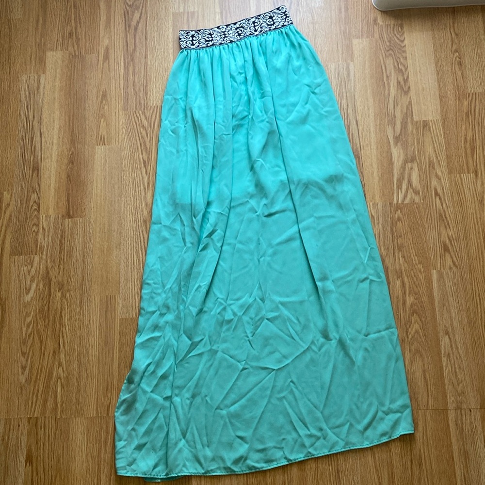 Long flowy turquoise skirt with short side split in a size medium.